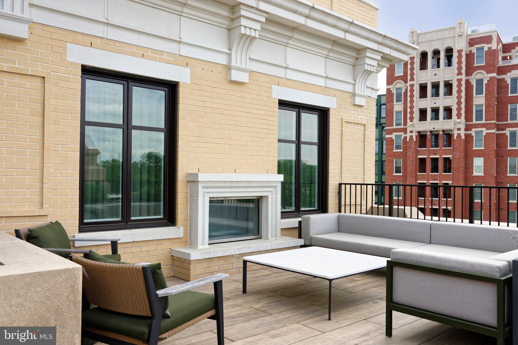 8551 Connecticut Avenue, Unit 207 Chevy Chase, MD 20815 - Photo 29 of 33 a living room with furniture a fireplace and a large window