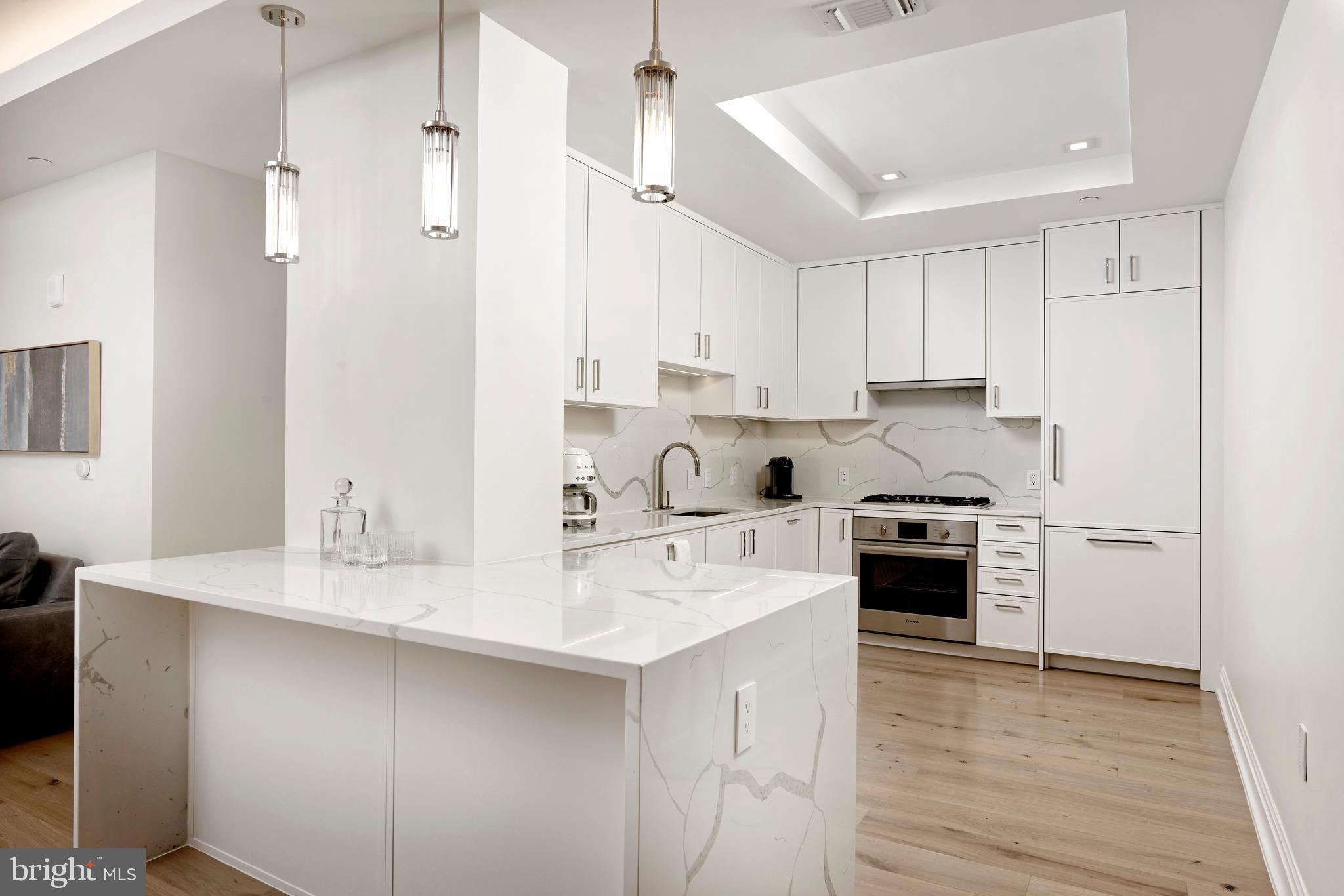 8551 Connecticut Avenue, Unit 207 Chevy Chase, MD 20815 - Photo 5 of 33 a kitchen with stainless steel appliances granite countertop a sink stove and refrigerator