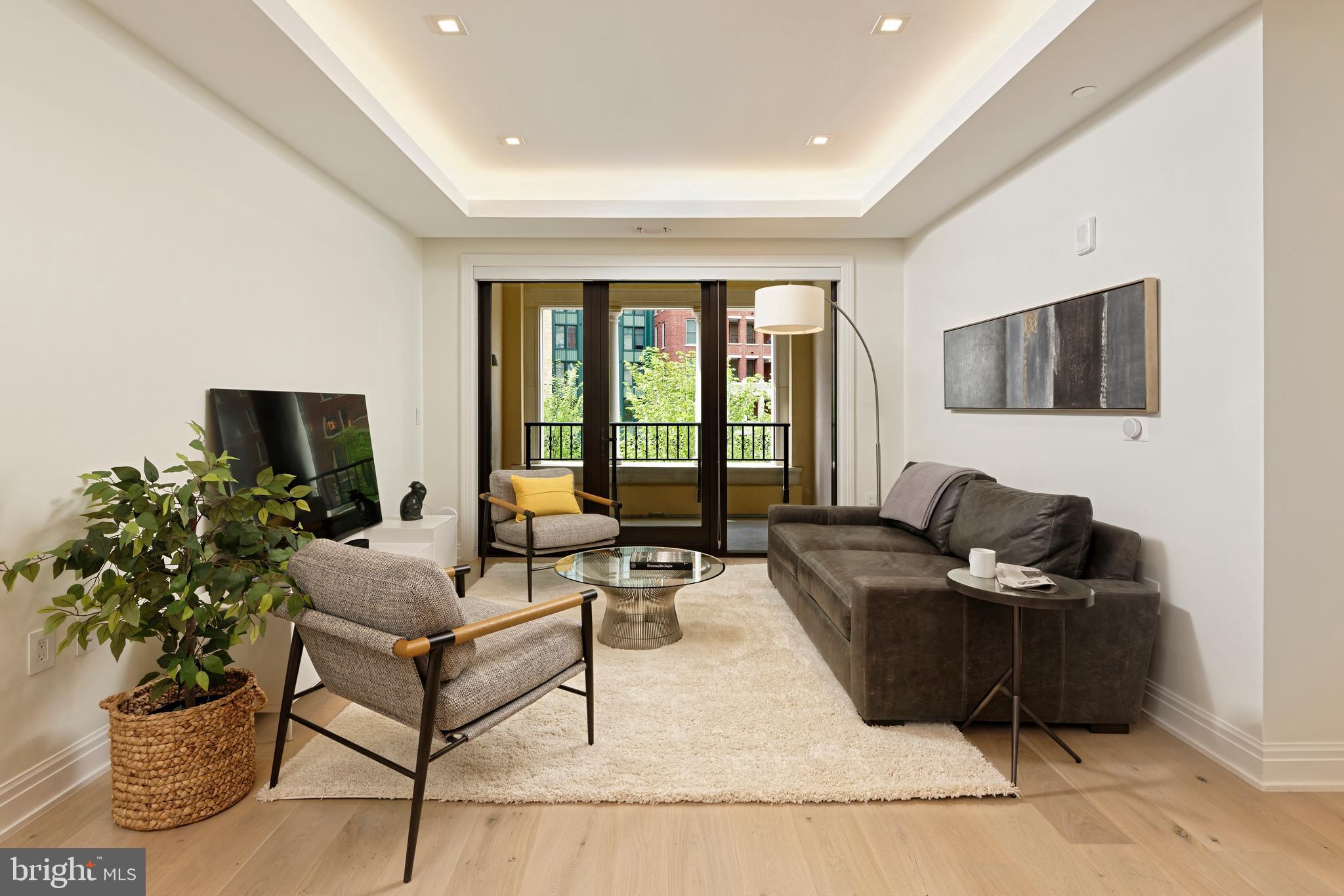8551 Connecticut Avenue, Unit 207 Chevy Chase, MD 20815 - Photo 8 of 33 a living room with furniture and a flat screen tv