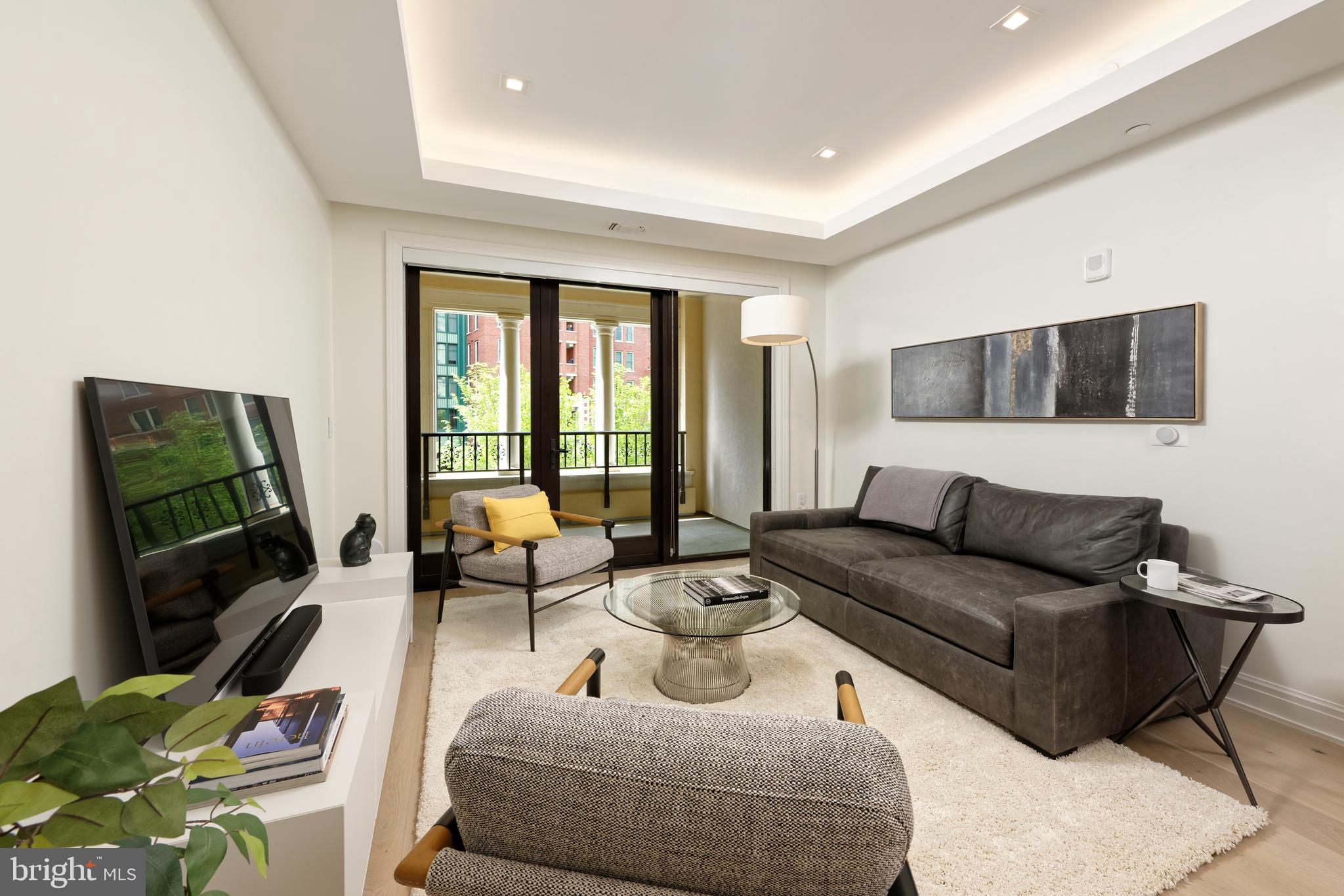 8551 Connecticut Avenue, Unit 207 Chevy Chase, MD 20815 - Photo 9 of 33 a living room with furniture and a flat screen tv