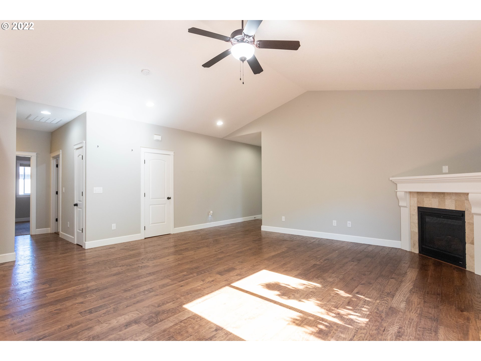 1914 South Sevier Road Ridgefield, WA 98642 - Photo 4 of 25 a view of an empty room with chandelier fan and wooden floor