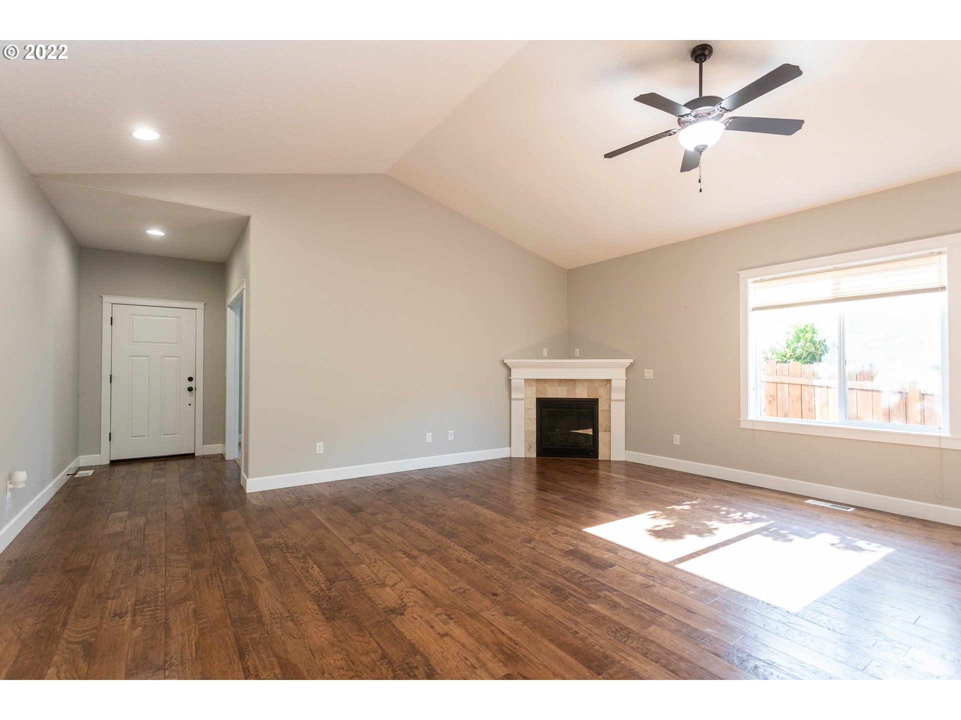 1914 South Sevier Road Ridgefield, WA 98642 - Photo 8 of 25 an empty room with wooden floor a ceiling fan and windows
