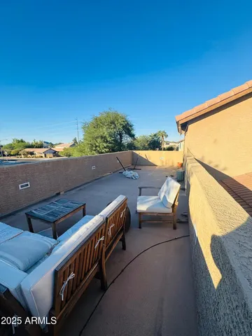 a view of roof deck with couches and sky view