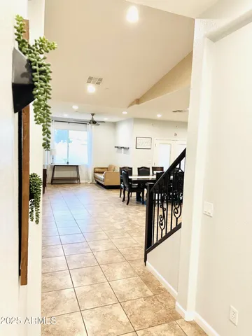 a lobby with furniture and flowers