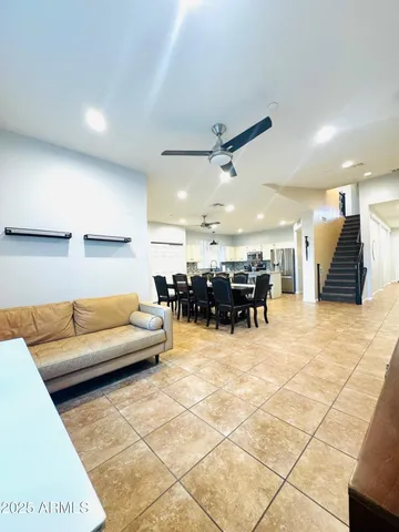a living room with furniture and kitchen view