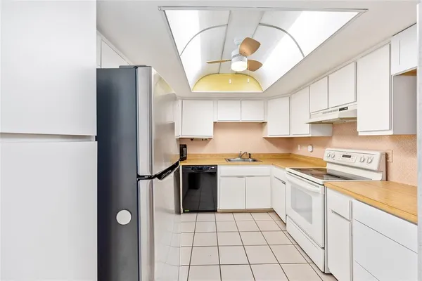 a spacious bedroom with a bed and a dresser