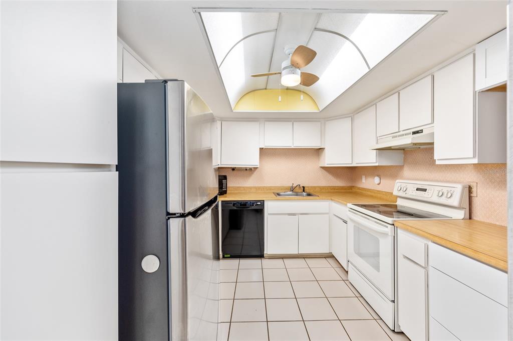 606 Midway Drive, Unit A Ocala, FL 34472 - Photo 12 of 27 a kitchen with a sink a refrigerator and cabinets