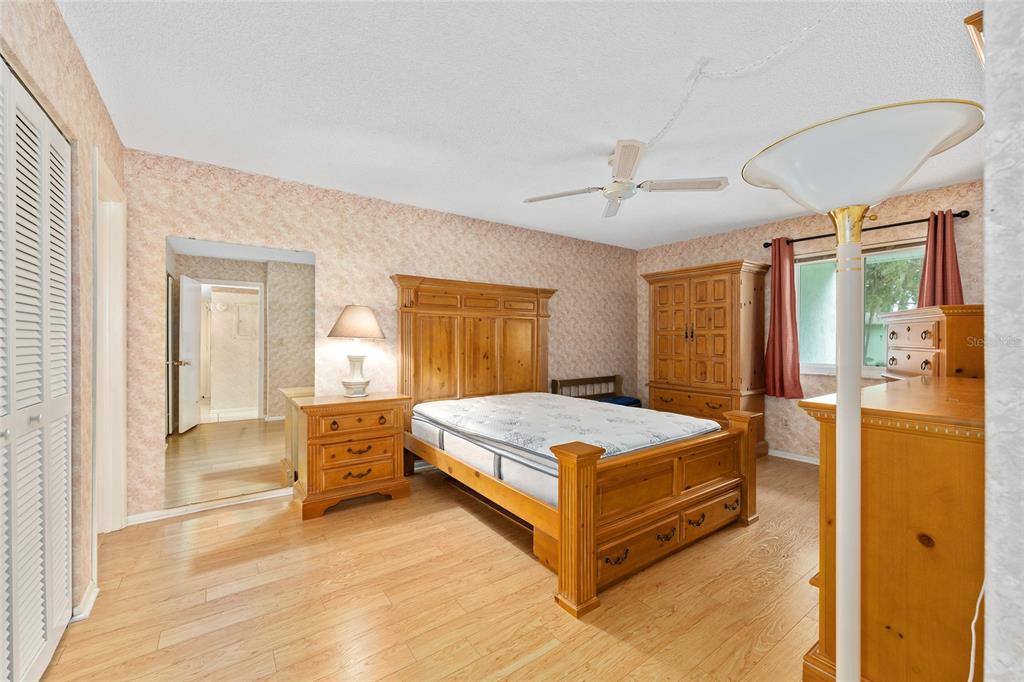 606 Midway Drive, Unit A Ocala, FL 34472 - Photo 14 of 27 a spacious bedroom with a bed and a dresser