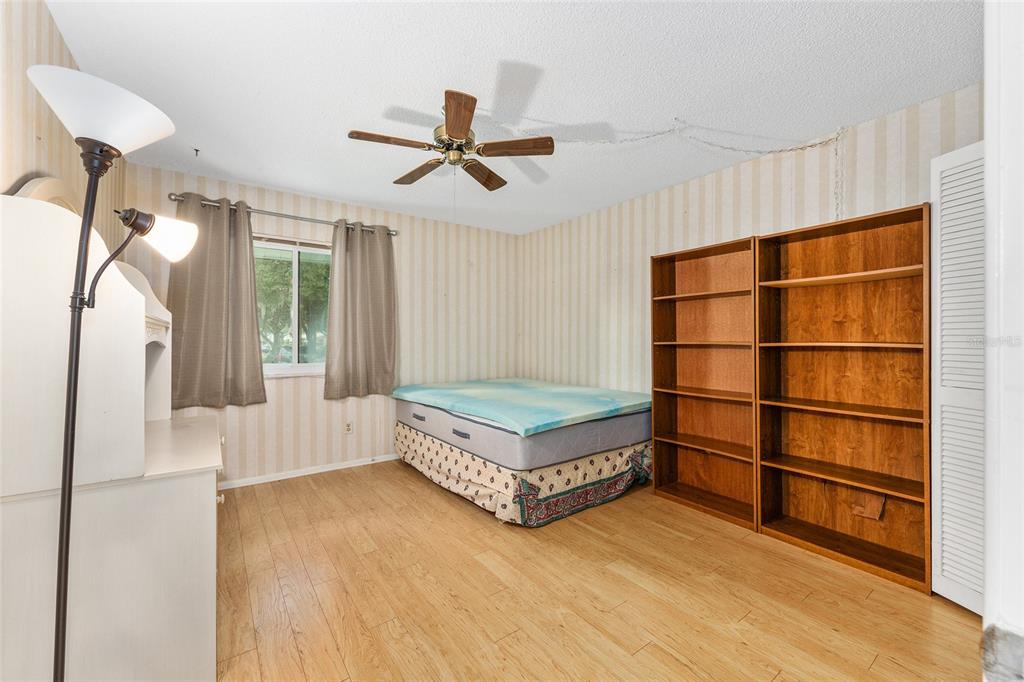 606 Midway Drive, Unit A Ocala, FL 34472 - Photo 17 of 27 a living room with a bed furniture and a window