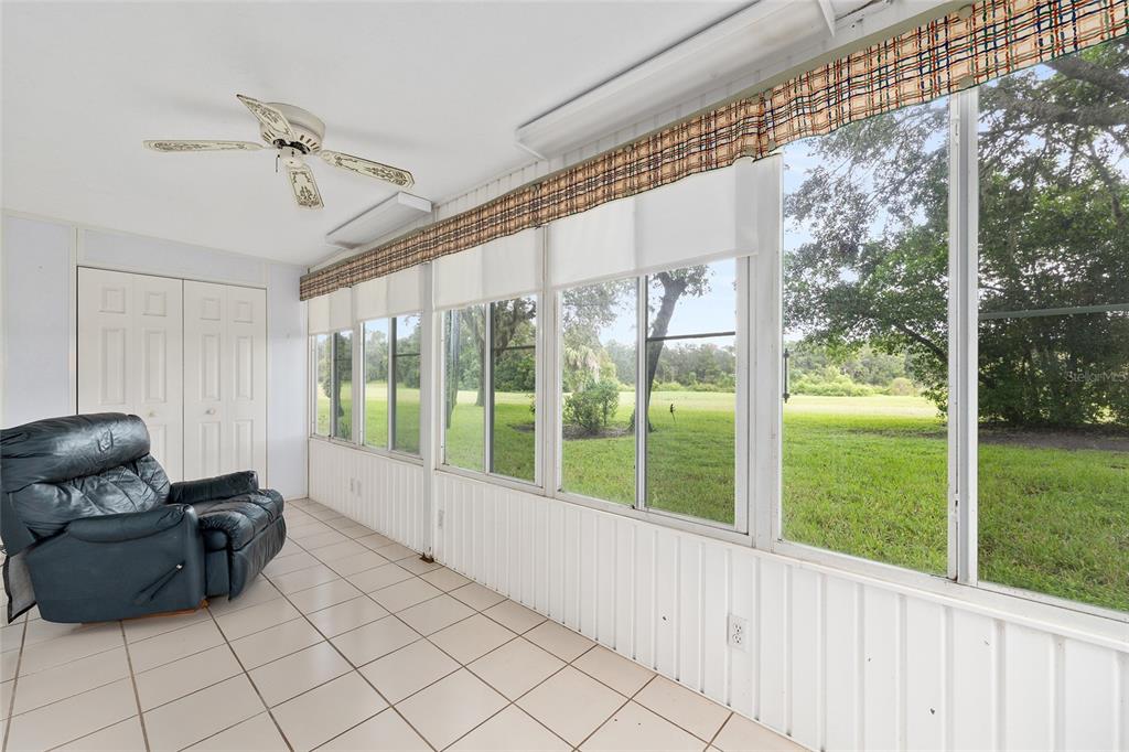 606 Midway Drive, Unit A Ocala, FL 34472 - Photo 22 of 27 a living room with furniture and a floor to ceiling window
