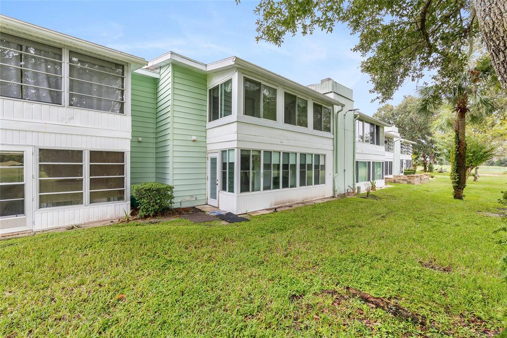 606 Midway Drive, Unit A Ocala, FL 34472 - Photo 25 of 27 a front view of a house with a garden
