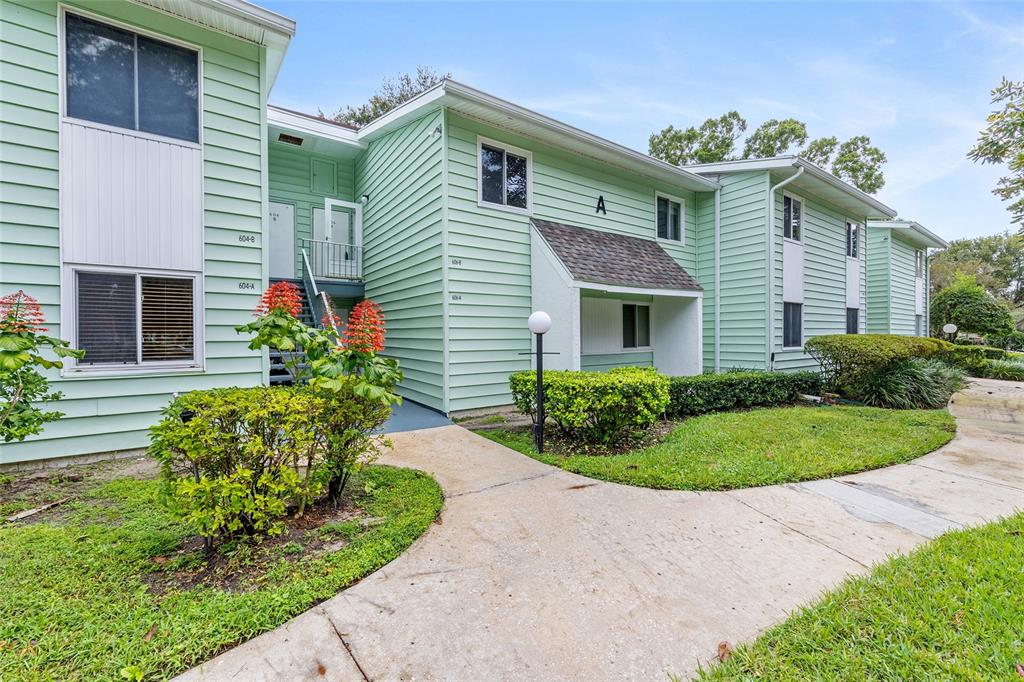 606 Midway Drive, Unit A Ocala, FL 34472 - Photo 3 of 27 a front view of a house with a garden