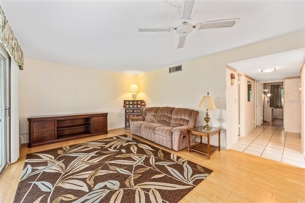 606 Midway Drive, Unit A Ocala, FL 34472 - Photo 8 of 27 a bedroom with furniture and a flat screen tv