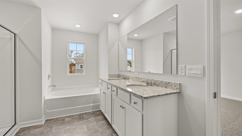 348 Belmont Drive Cartersville, GA 30120 - Photo 21 of 41 a bathroom with a sink double vanity granite tub and a mirror