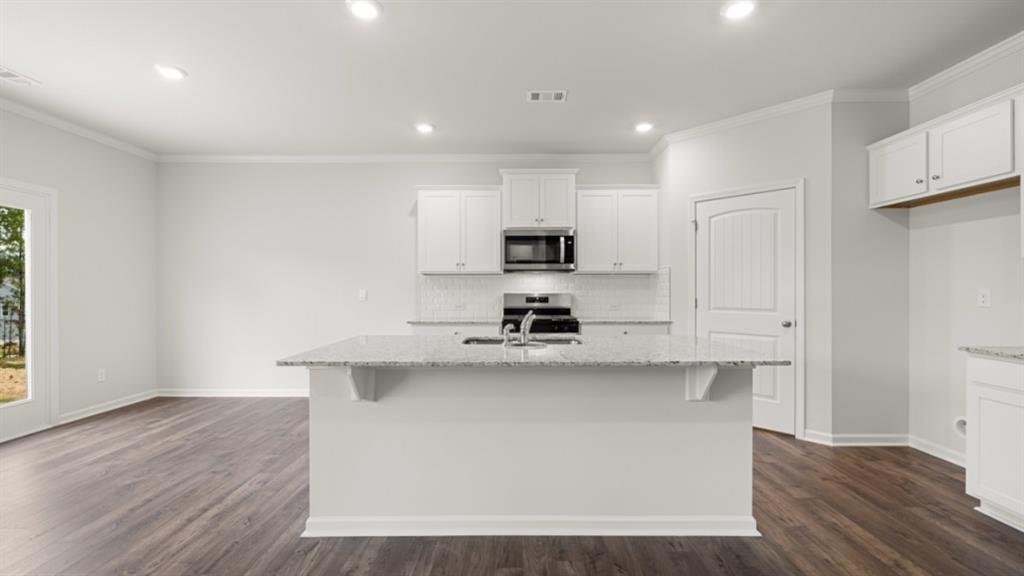 348 Belmont Drive Cartersville, GA 30120 - Photo 6 of 41 a kitchen with stainless steel appliances a sink a stove a refrigerator and cabinets