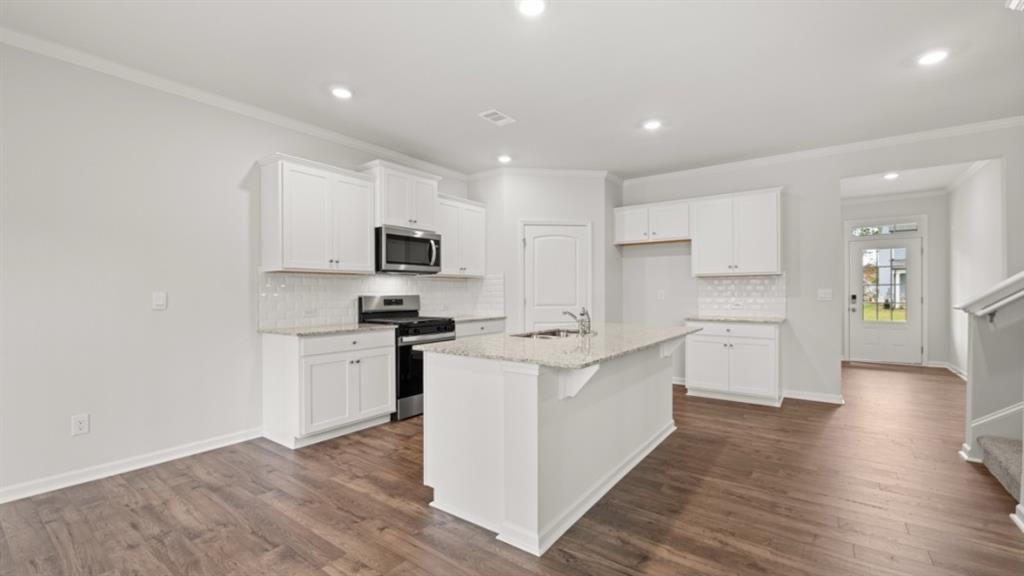 348 Belmont Drive Cartersville, GA 30120 - Photo 7 of 41 a kitchen with a sink a counter top space stainless steel appliances and cabinets