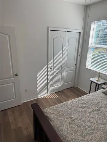a living room with furniture a window and a lamp