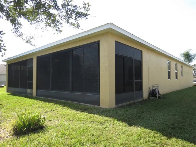 a view of yard with green space and trees in the background
