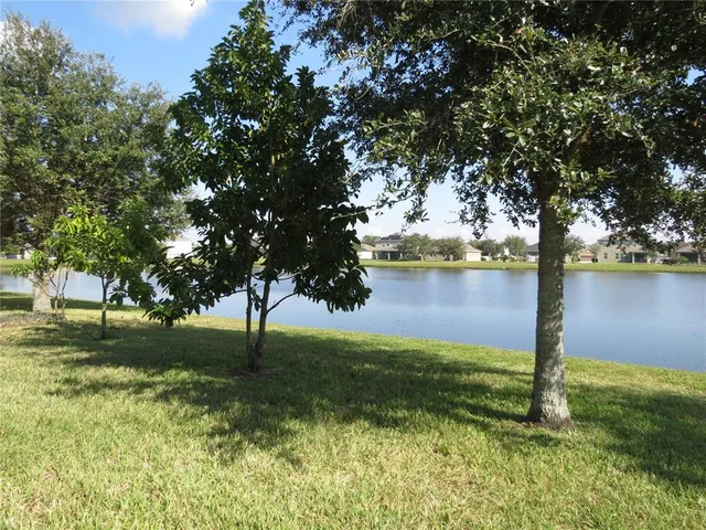 a view of a lake with houses in the back