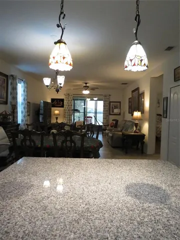 a view of a big room with chandelier kitchen view and a chandelier