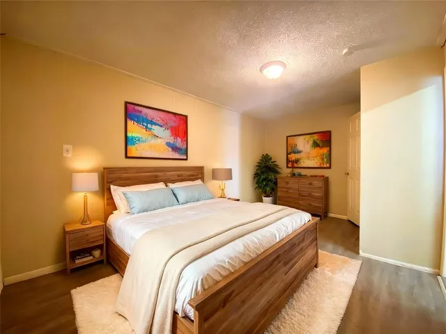 a spacious bedroom with a bed and a desk