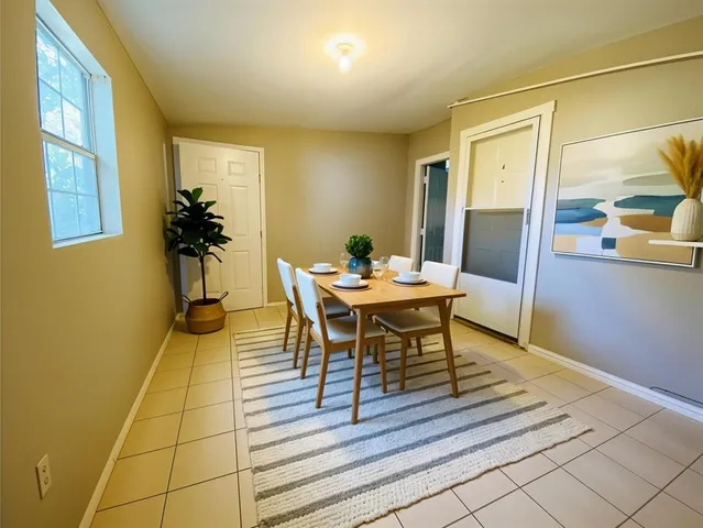 a dining room with furniture and wooden floor