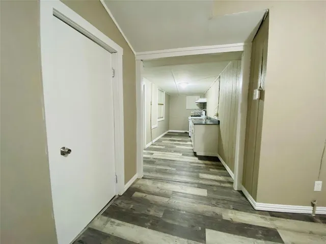 a view of a room with a sink and cabinets
