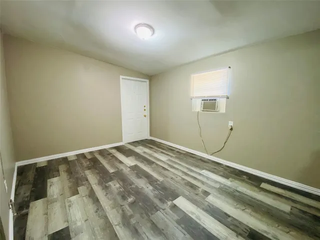 a view of a room with wooden floor and fan