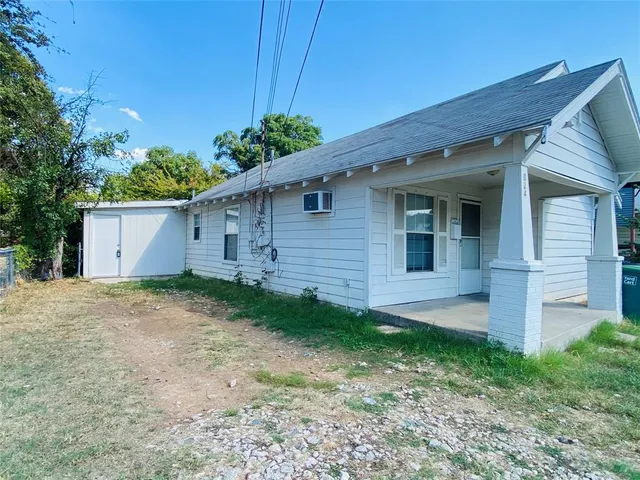 a front view of house with a garden