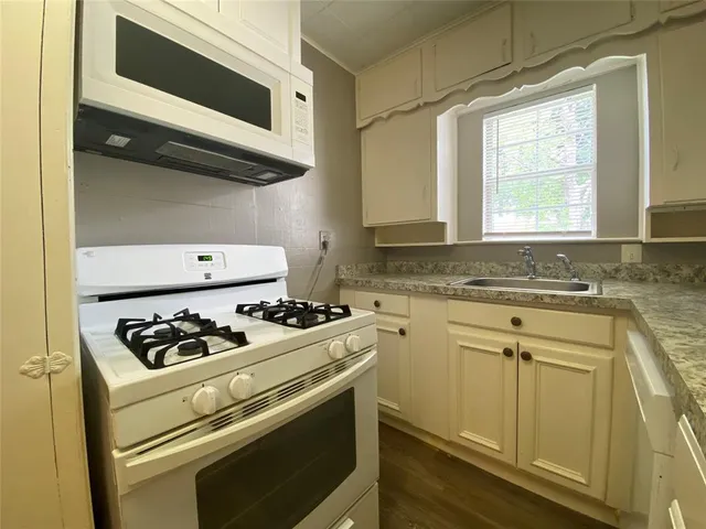 a stove top oven sitting inside of a kitchen