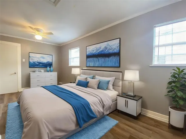 a bedroom with a bed and a potted plant