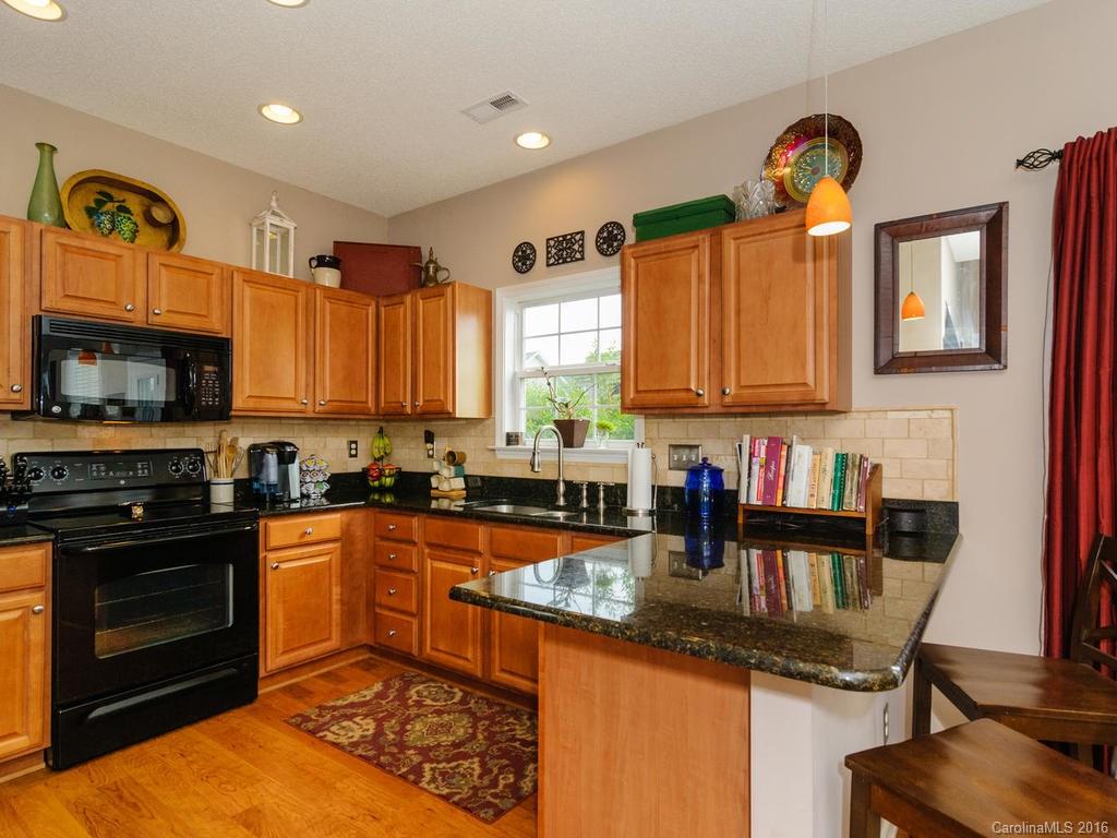 47 Lumber River Road, Unit 183 Fletcher, NC 28732 - Photo 8 of 24 a kitchen with granite countertop a stove sink and cabinets