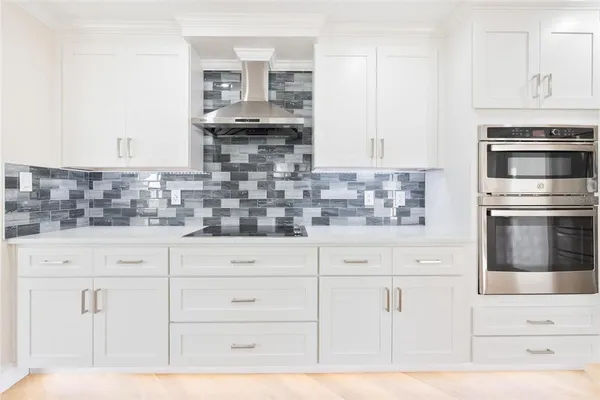 a kitchen with stainless steel appliances white cabinets and a sink