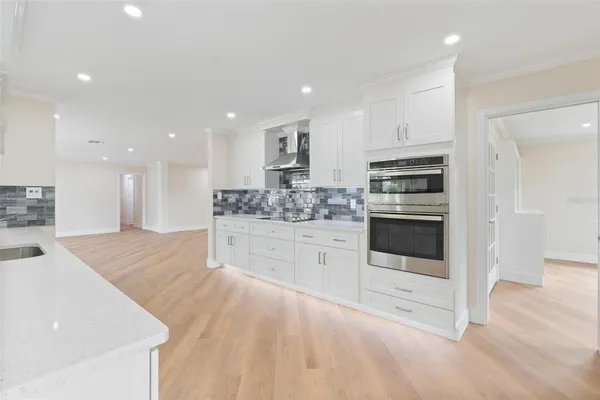 a kitchen with stainless steel appliances kitchen island granite countertop a stove a sink and a refrigerator