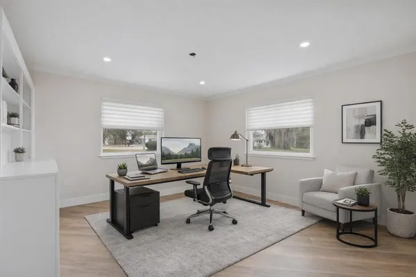 a view of a workspace with furniture and a window