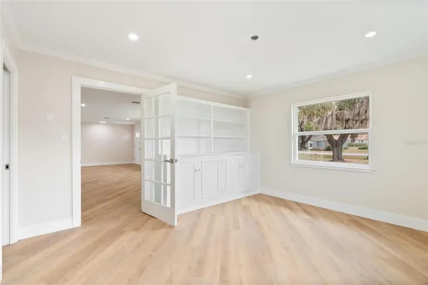 an empty room with a empty space and windows