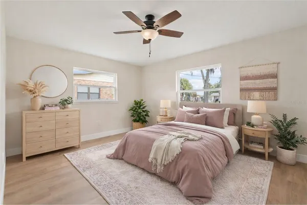 a bed room with a bed and a potted plant