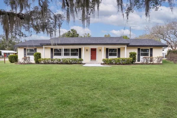 a front view of house with yard and green space