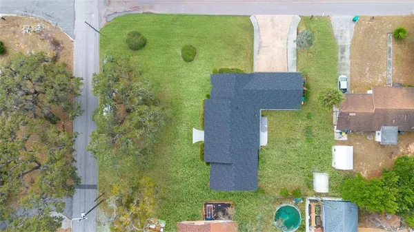 an aerial view of a house with a yard
