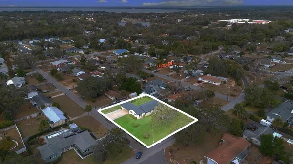 an aerial view of a house with a yard