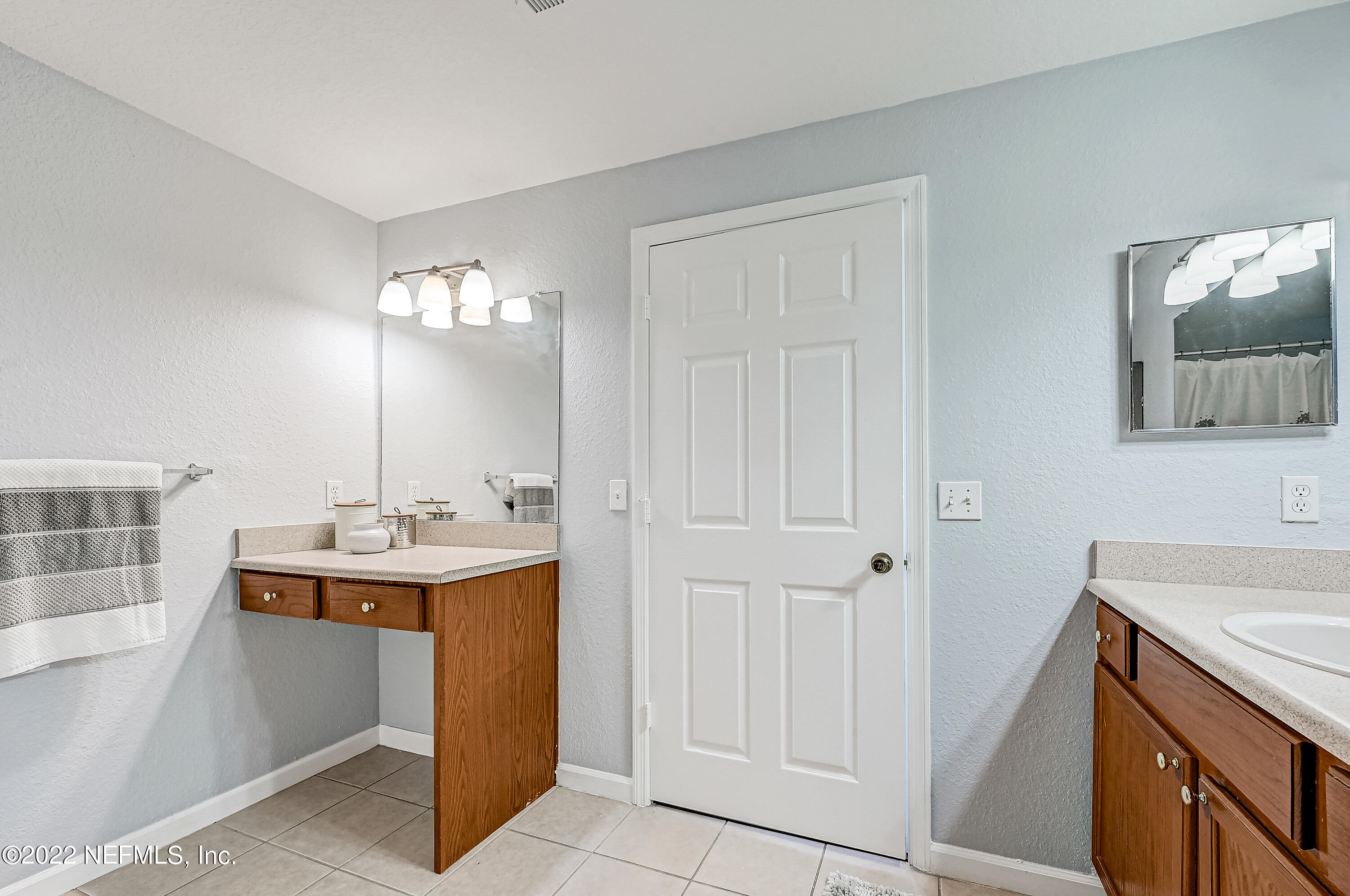 8550 Touchton Road, Unit 1132 Jacksonville, FL 32216 - Photo 12 of 43 a bathroom with a sink and a mirror