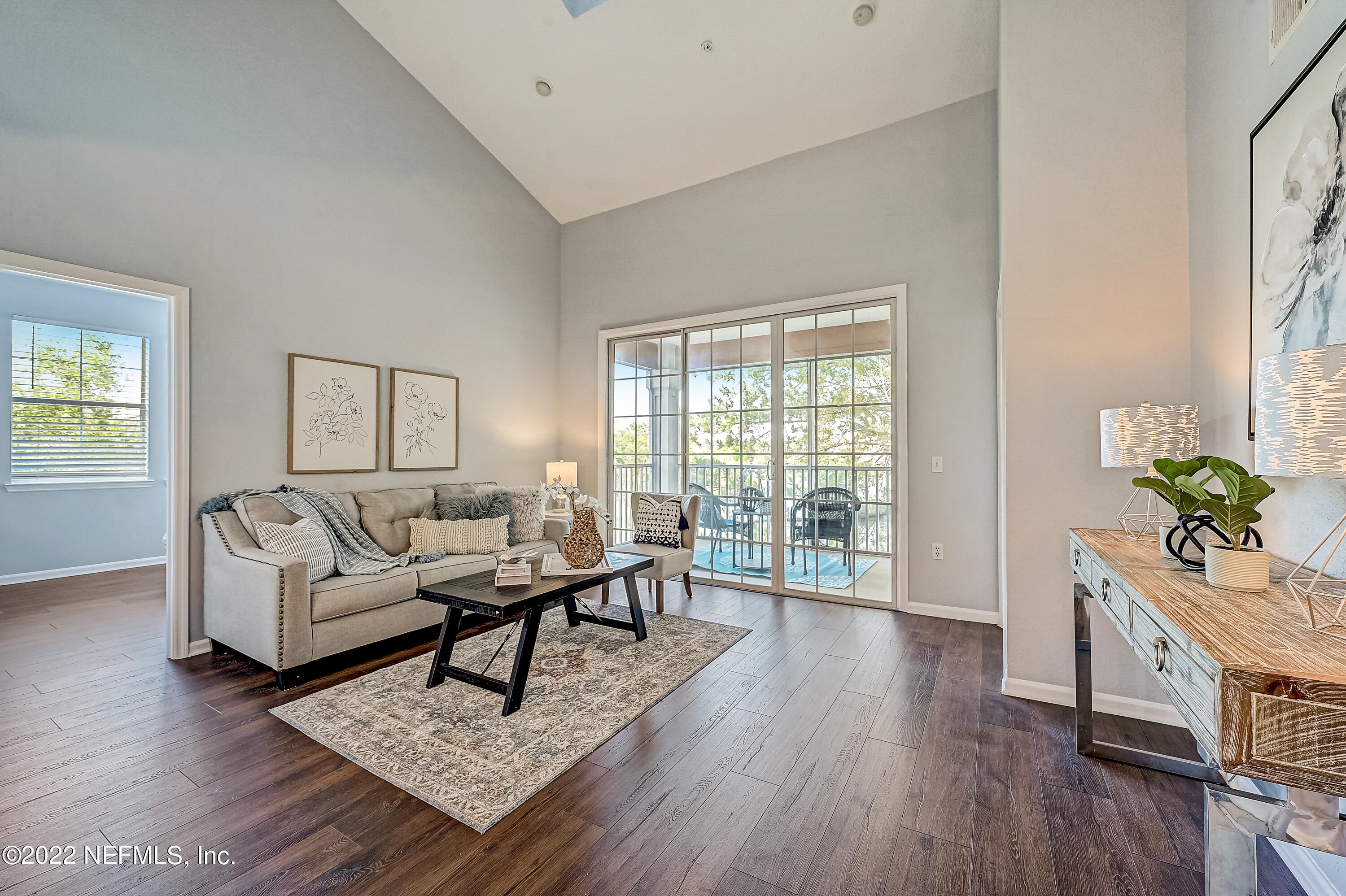 8550 Touchton Road, Unit 1132 Jacksonville, FL 32216 - Photo 2 of 43 a living room with furniture and a wooden floor