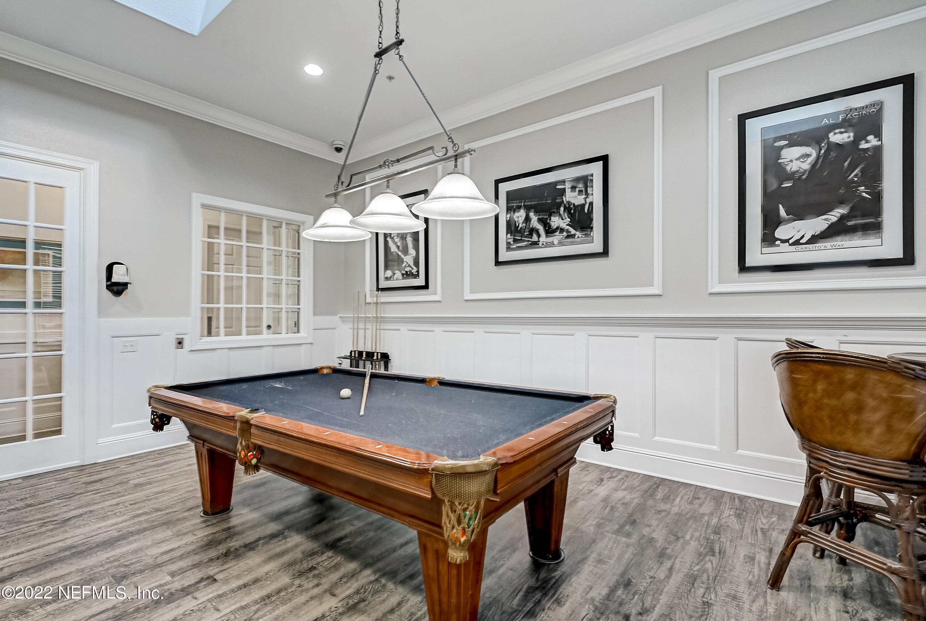 8550 Touchton Road, Unit 1132 Jacksonville, FL 32216 - Photo 34 of 43 a dining room with wooden floor and a chandelier