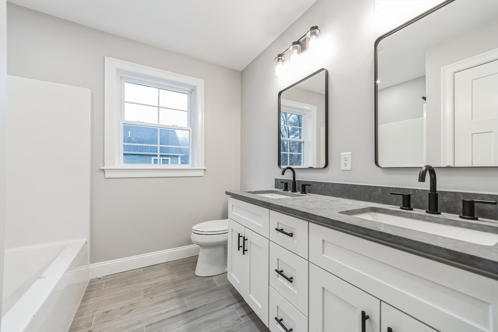 36 Gove Road Billerica, MA 01821 - Photo 15 of 30 a bathroom with a granite countertop toilet sink and mirror