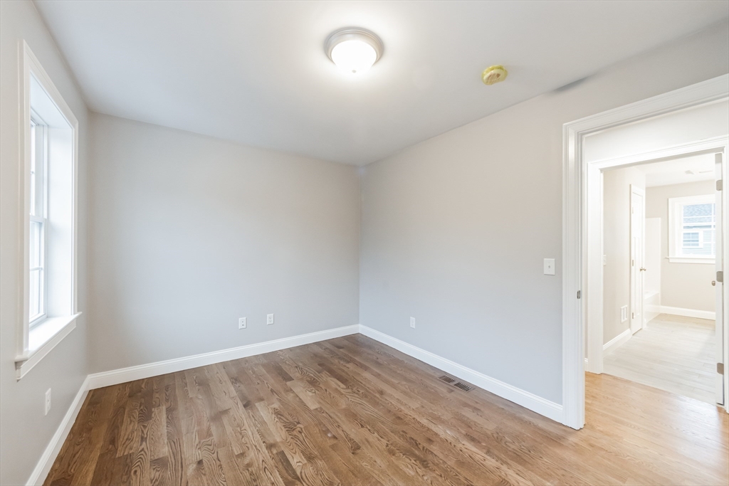 36 Gove Road Billerica, MA 01821 - Photo 18 of 30 an empty room with wooden floor and windows