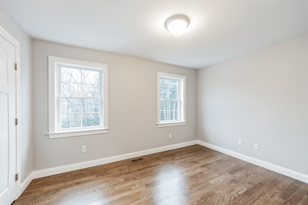 36 Gove Road Billerica, MA 01821 - Photo 23 of 30 an empty room with wooden floor and windows