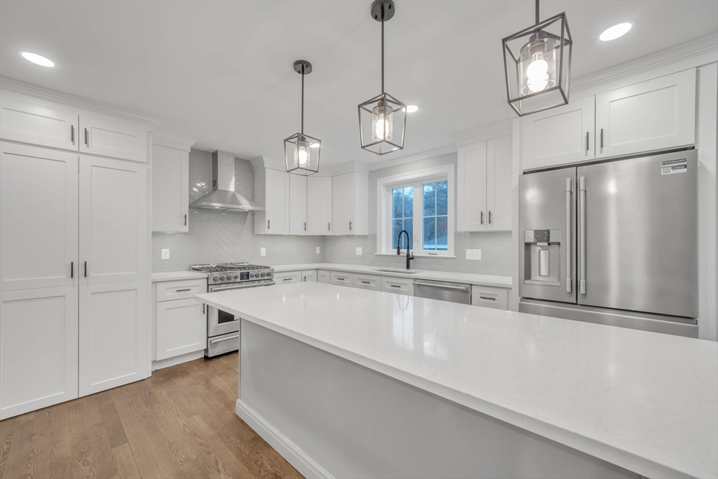 36 Gove Road Billerica, MA 01821 - Photo 5 of 30 a large kitchen with cabinets a sink stainless steel appliances and a chandelier