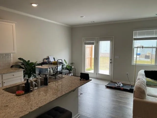 a front view of a house with barbeque and wooden fence