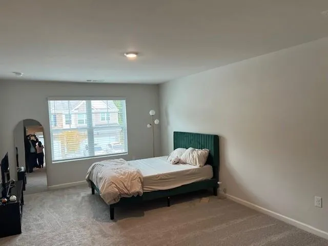 a bedroom with a bed and a tv