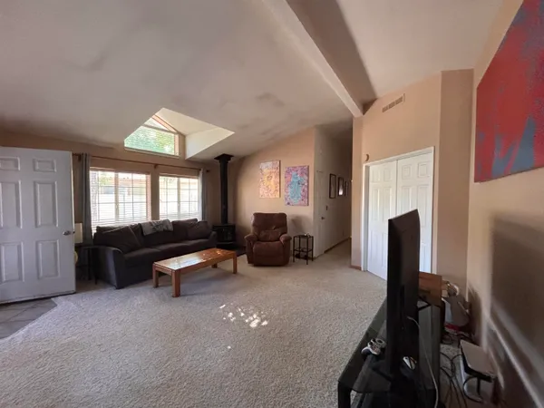 a living room with furniture window and a flat screen tv